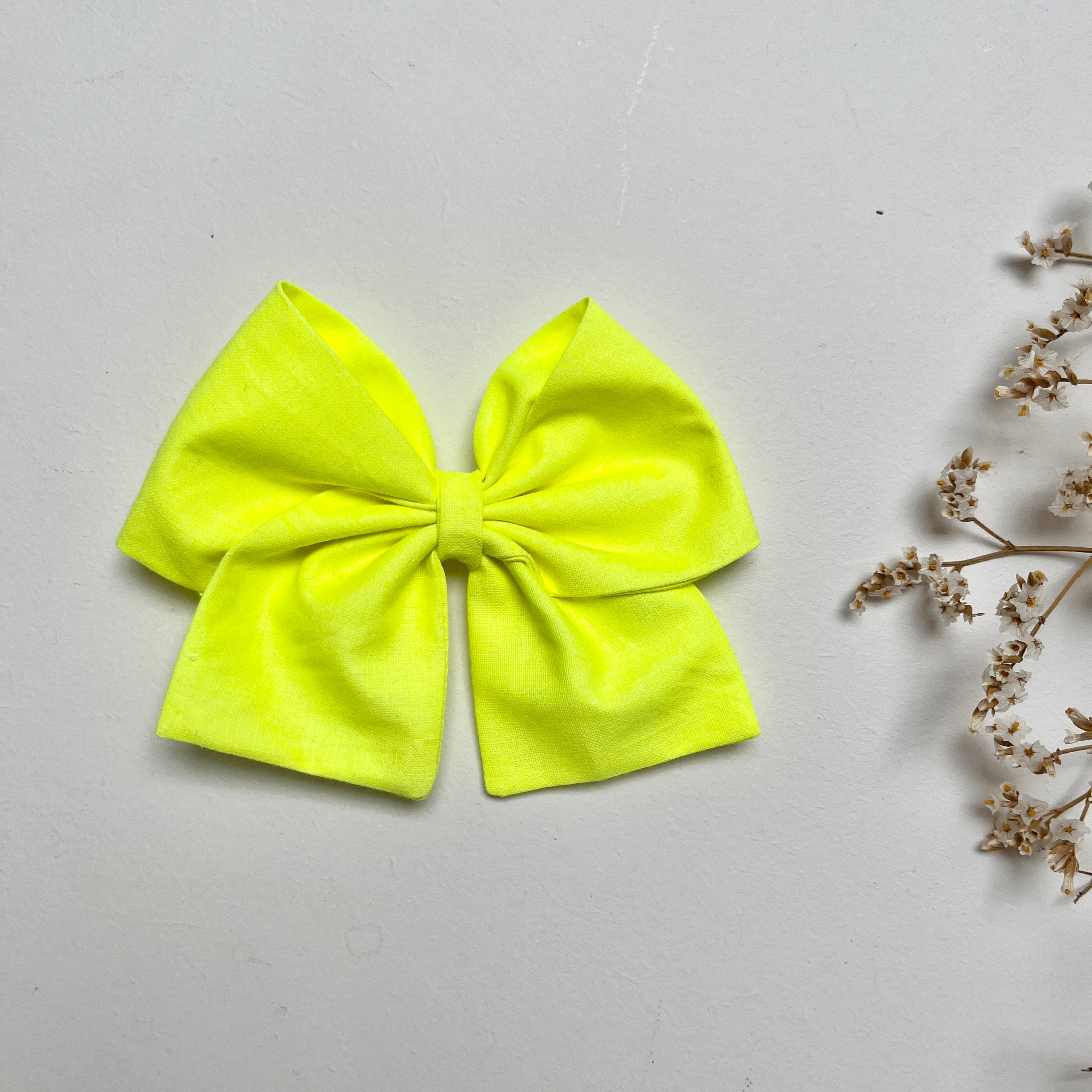 La barrette à gros noeud Brunette unie jaune fluo